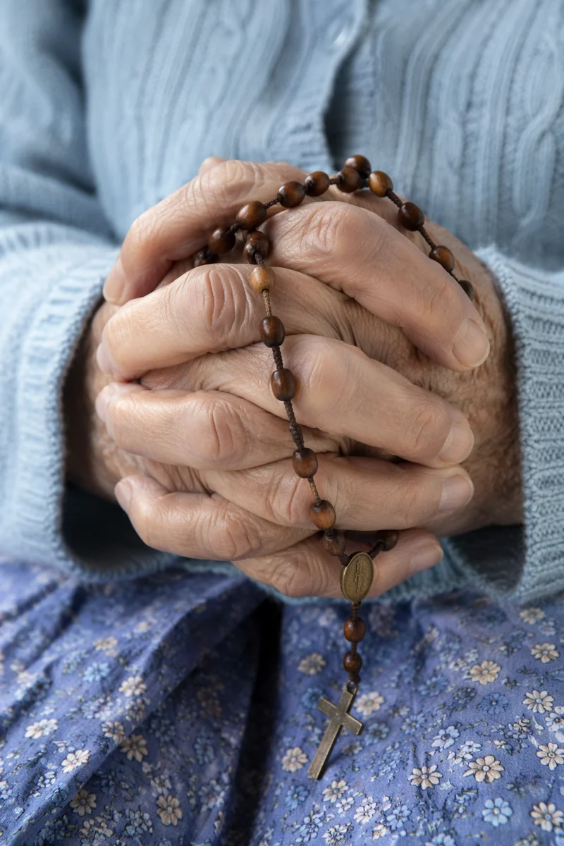 Elderly Hands Holding Rosary in Prayer