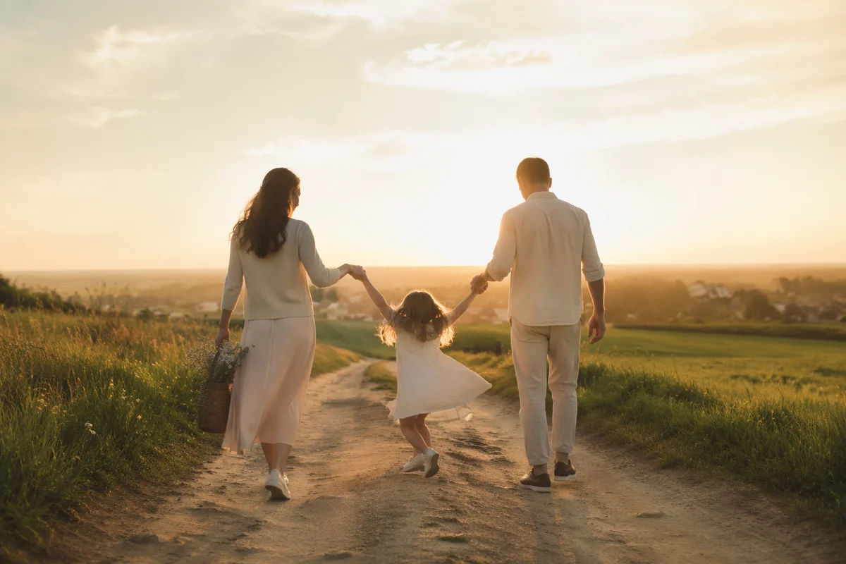 Family Walking Country Road at Sunset