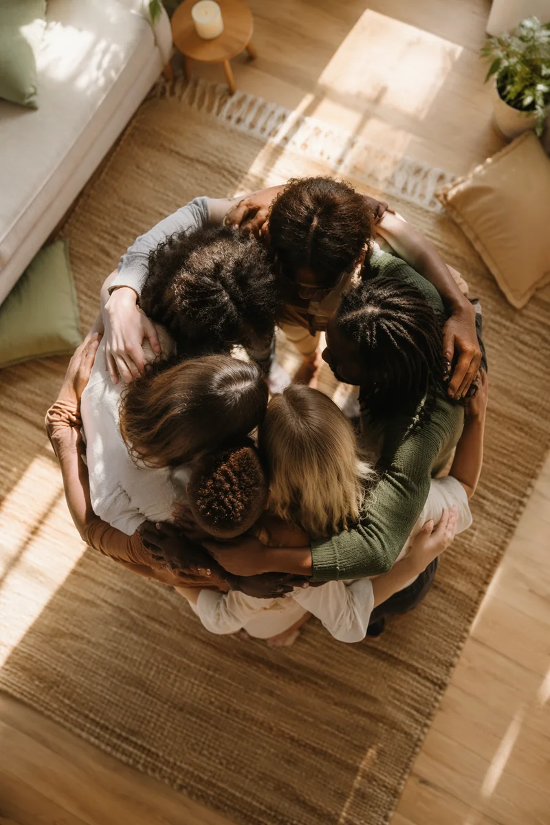 Overhead Friends Hug Circle in Sunlit Room