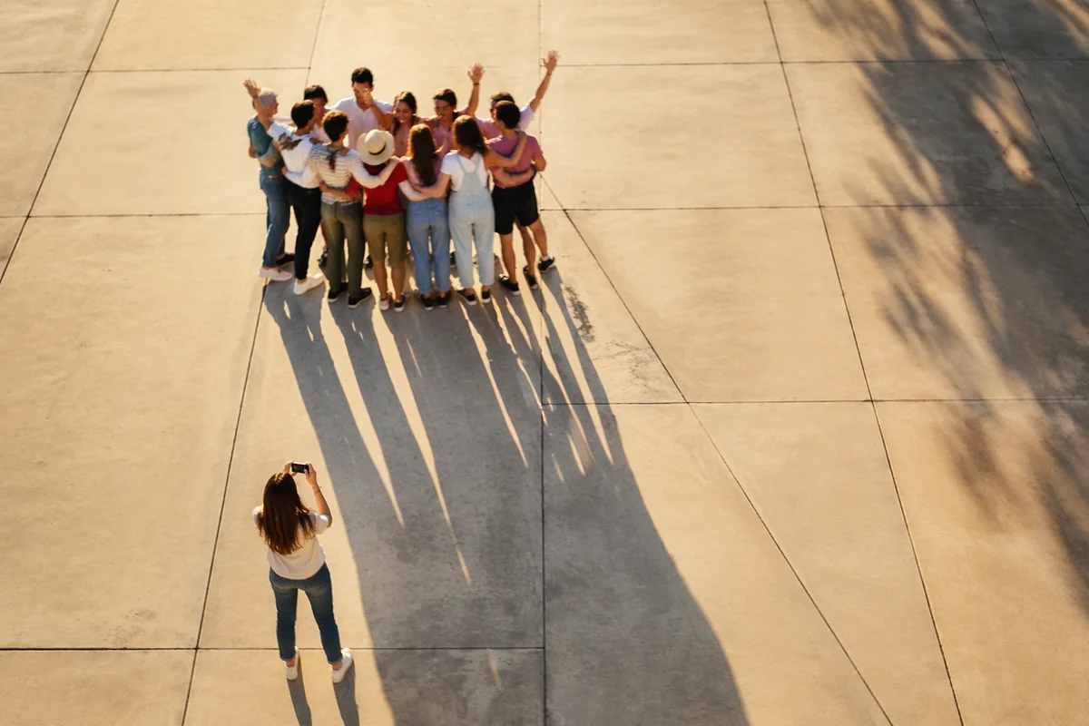 Overhead Friends Group Hug on Sunlit Plaza