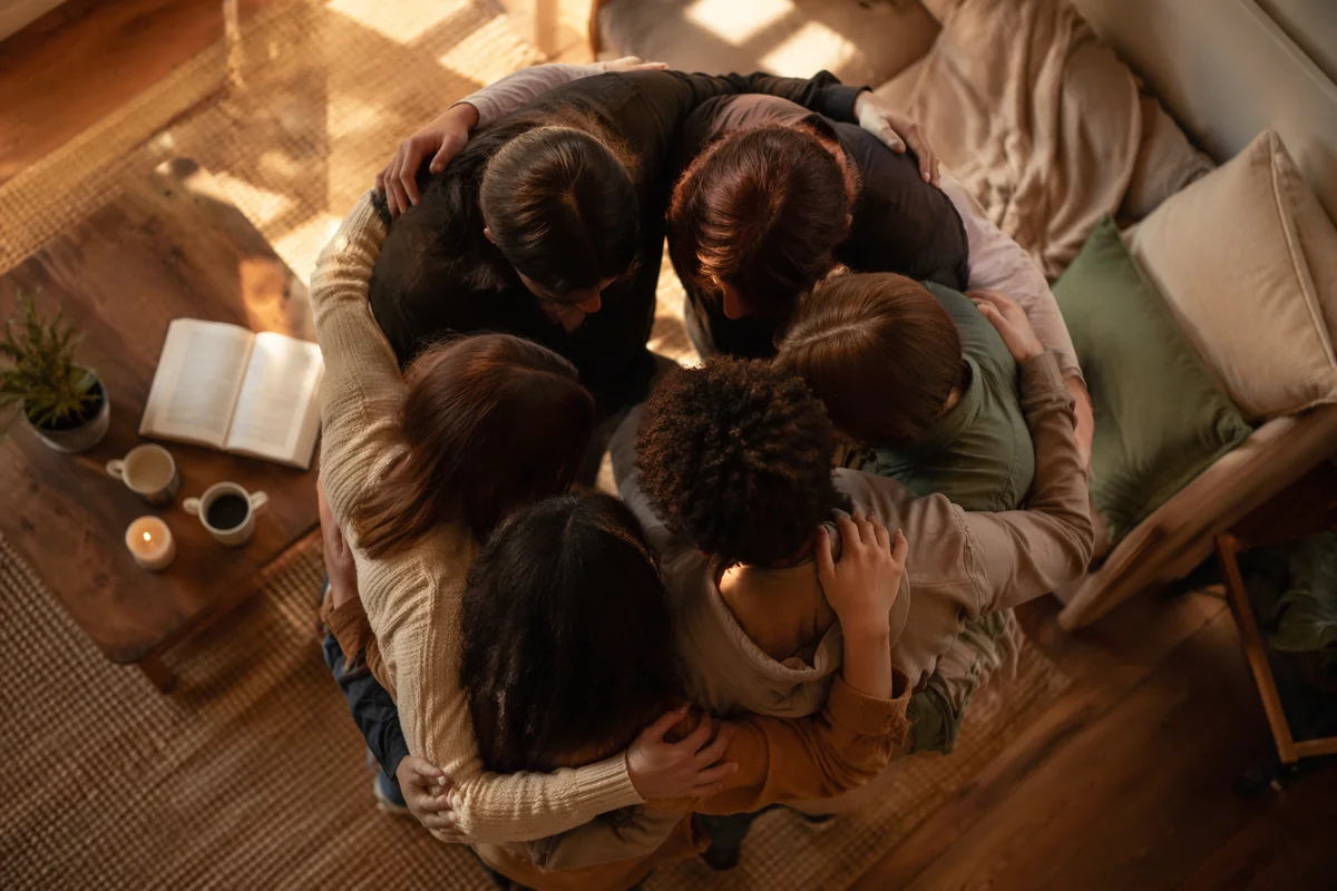 Overhead Friends Circle Hug in Warm Living Room