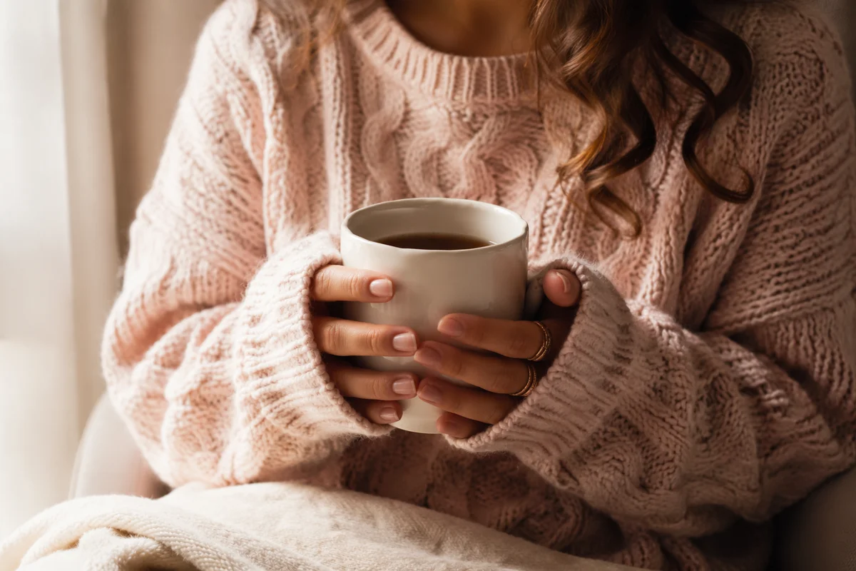 Cozy Hands Holding Warm Mug