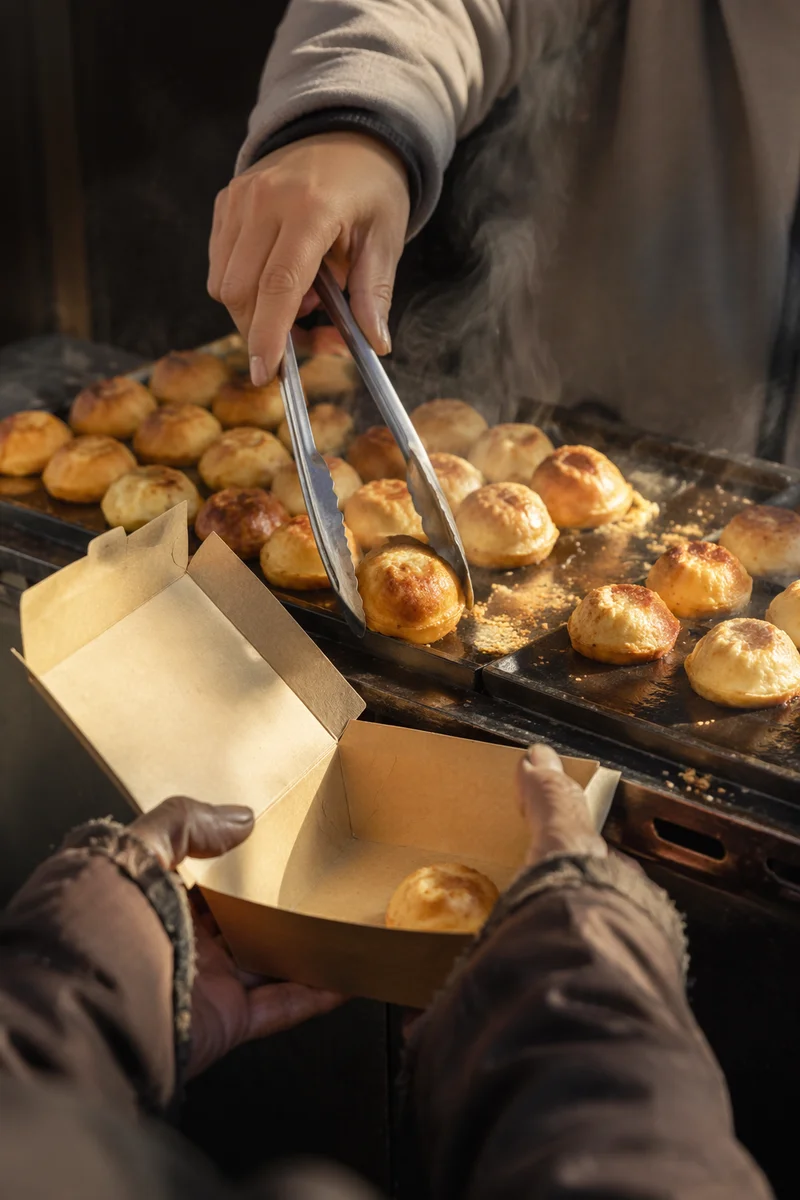 Volunteer Hands Serving Warm Pastries