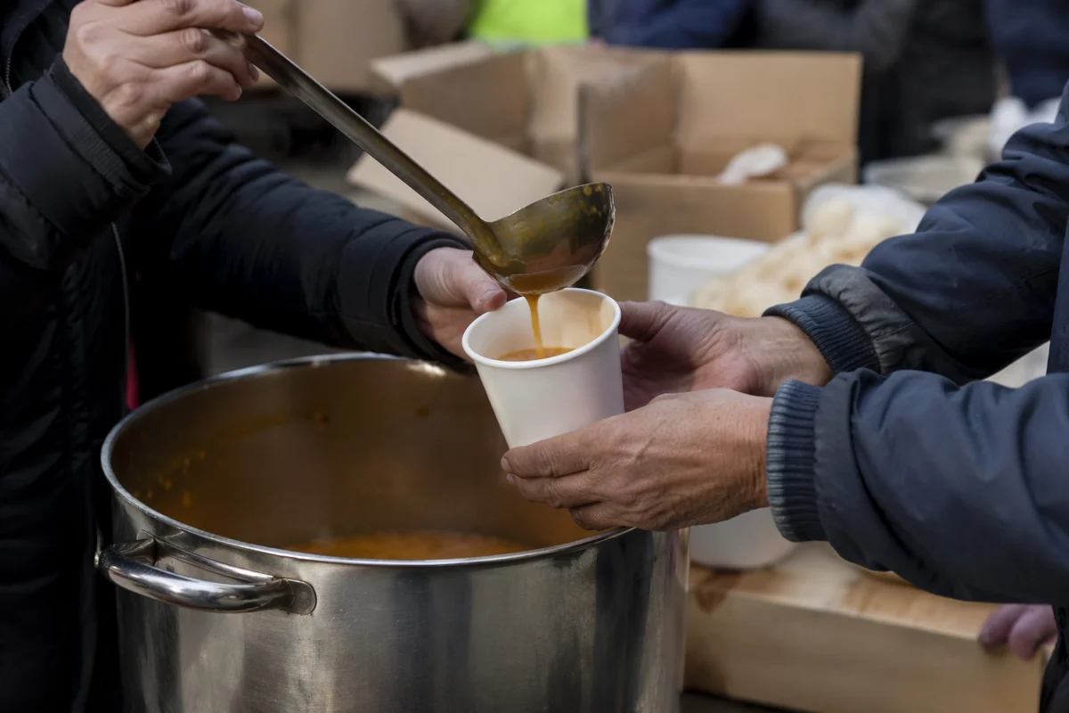 Volunteers Serving Hot Soup Outdoors