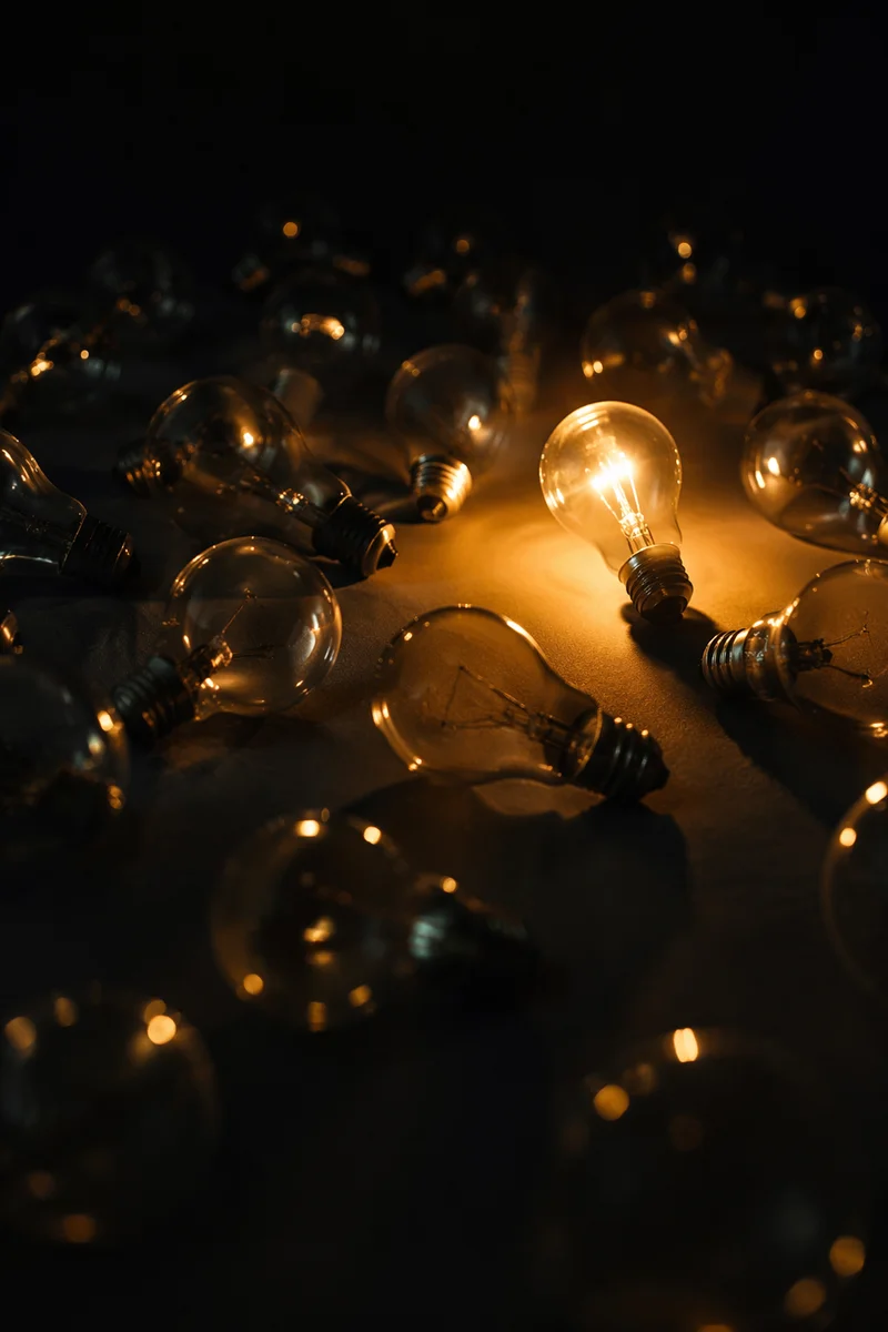 Glowing Bulb of Hope in Darkness