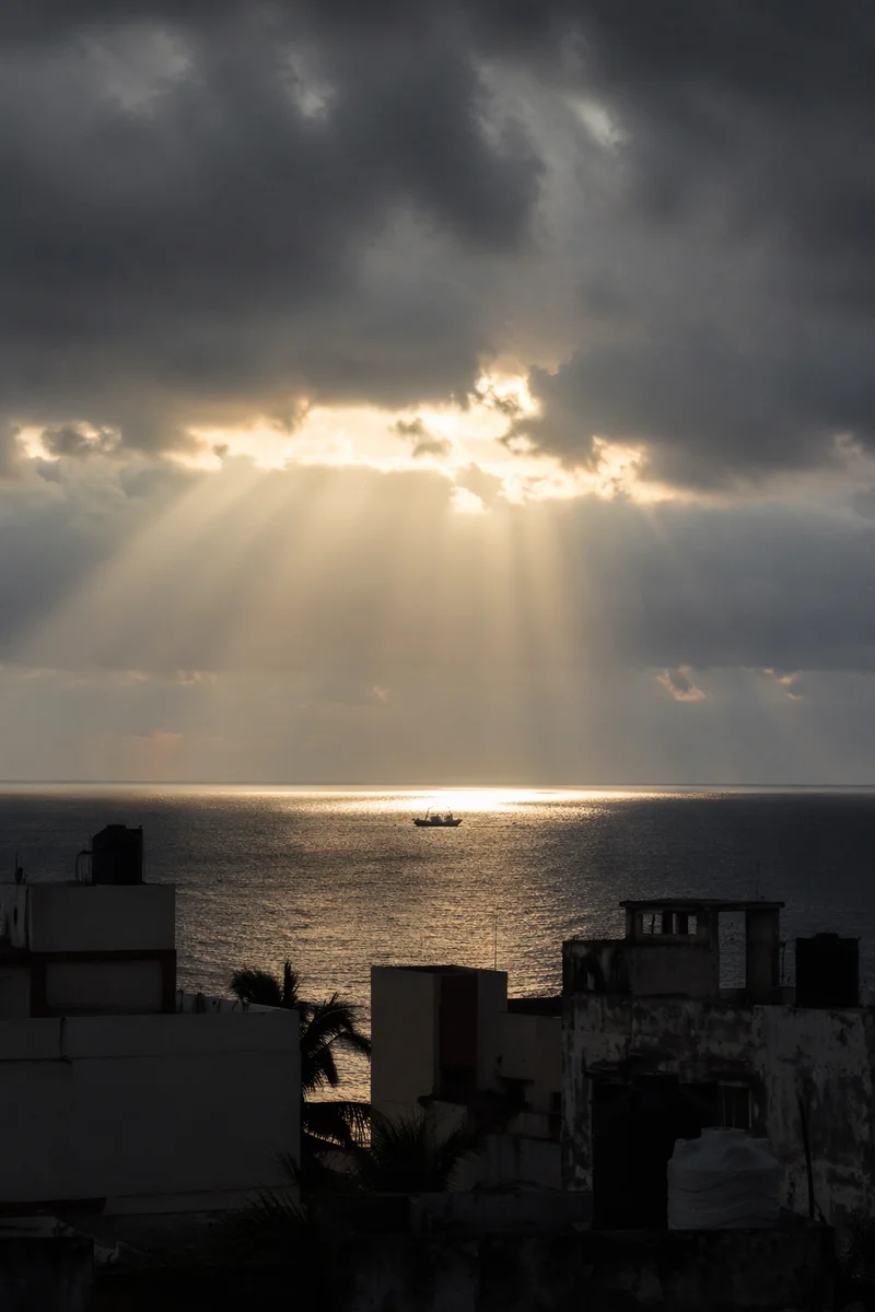 Hopeful Sunlight Over Stormy Coastal Rooftops