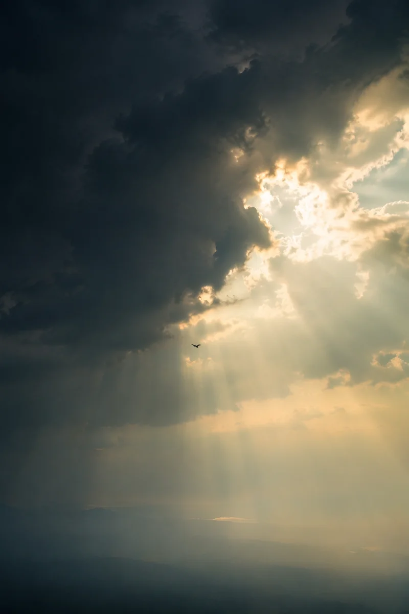 Hopeful Sunlight Through Dark Storm Clouds