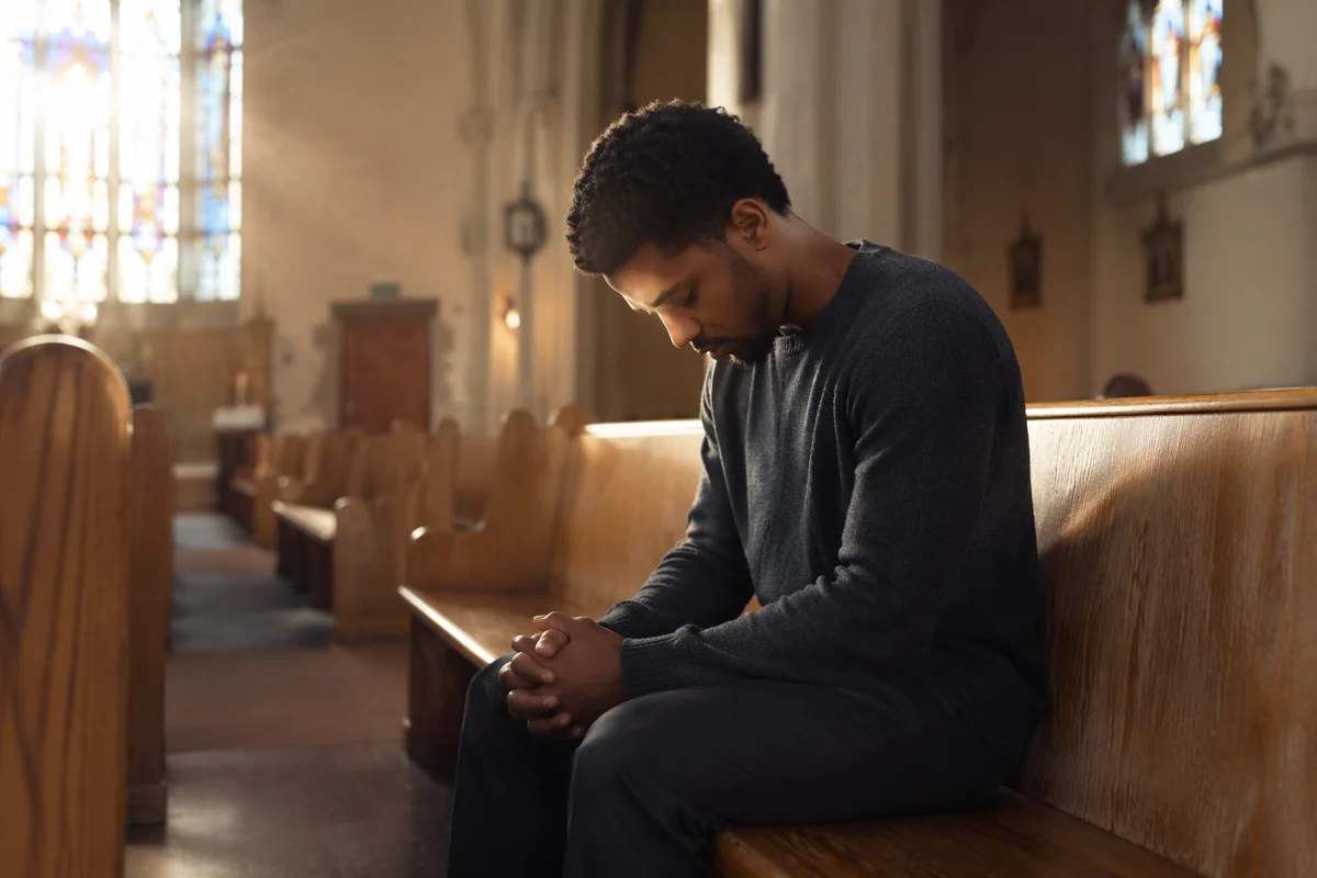 Man Sitting Alone on Church Pew