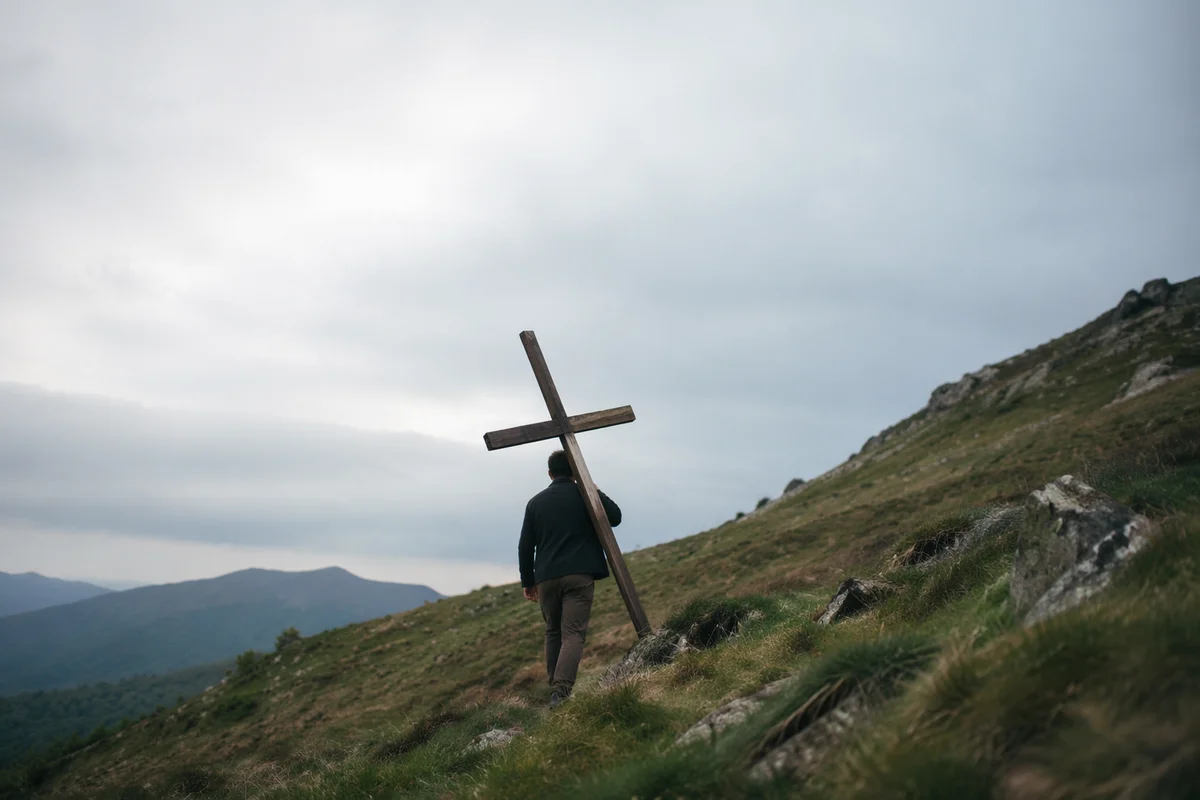 Lone Believer Carrying Cross Uphill