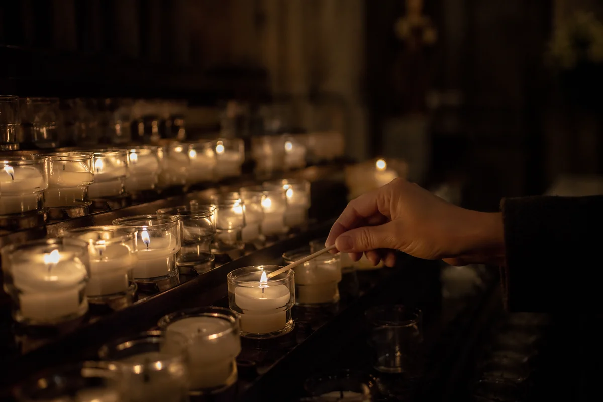 Lighting Votive Candles in a Dark Church