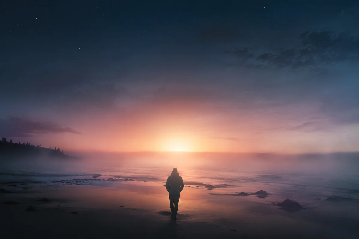 Silhouette Walking Through Coastal Fog Toward Dawn