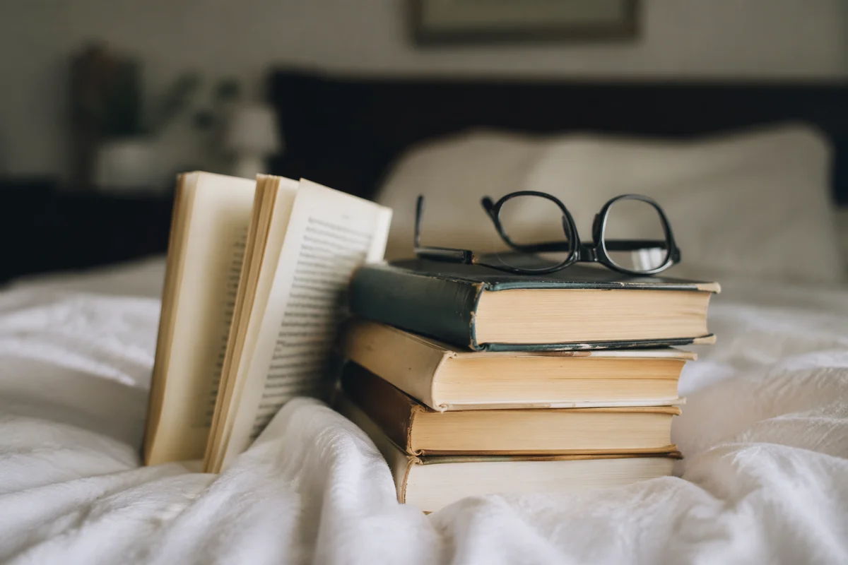 Cozy Bedside Books with Reading Glasses