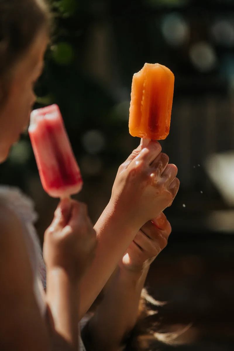 Kids Enjoying Melting Popsicles in Summer