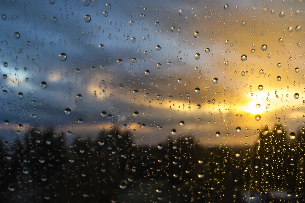 Peaceful Sunrise Through Rain Droplets