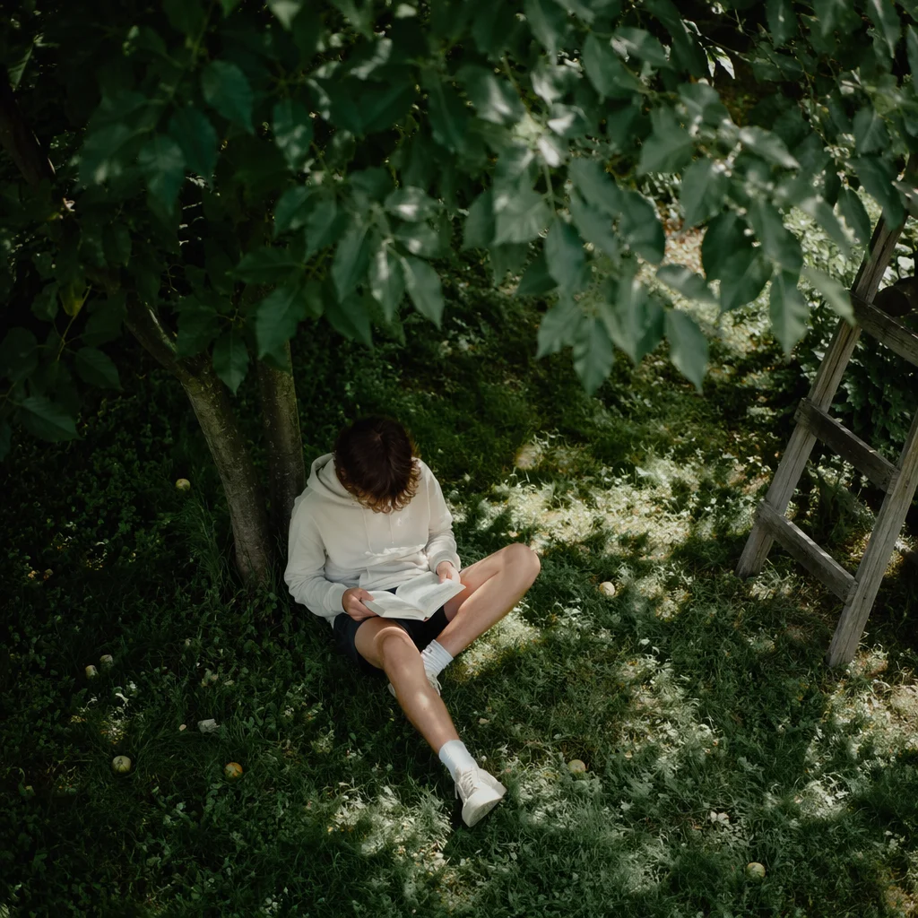 Teen Reading Bible Beneath Garden Tree Shade