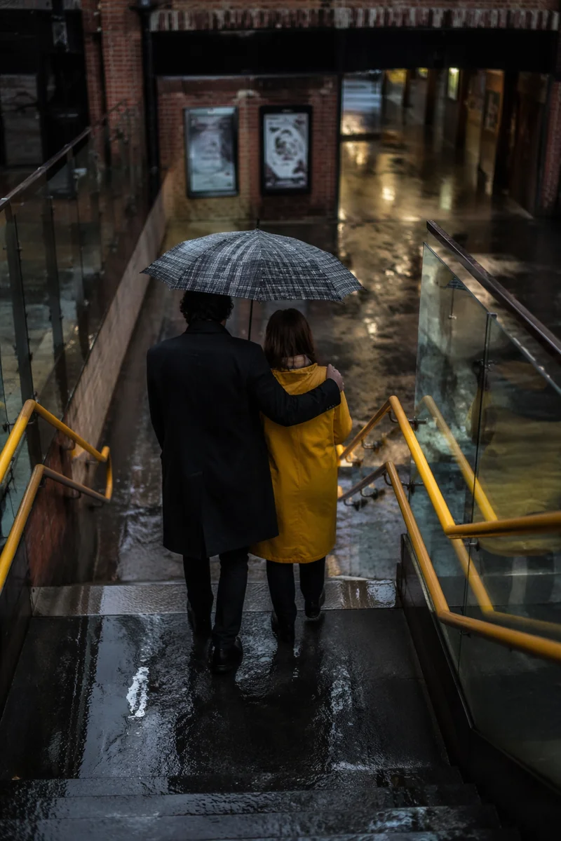 Shared Umbrella Kindness in Rainy Underpass