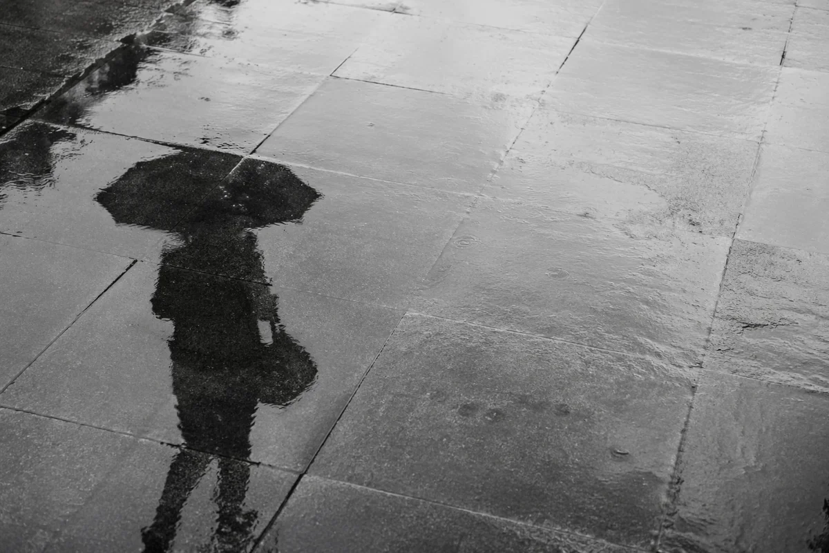 Rainy Street Puddle Reflection with Umbrella