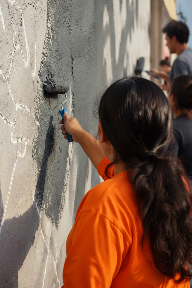 Community Volunteers Painting a Neighborhood Wall