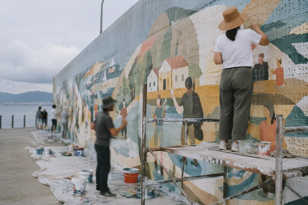 Community Volunteers Painting Waterfront Mural Together