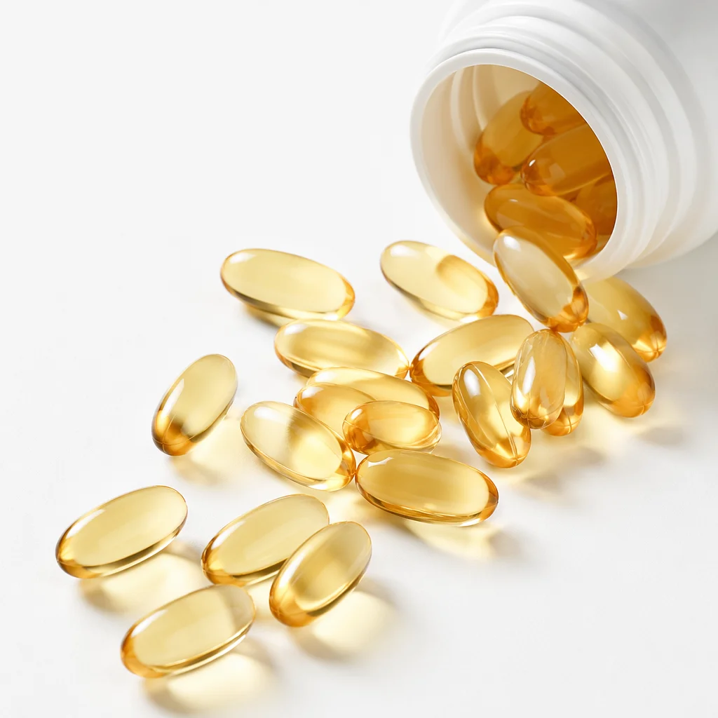 Golden Softgel Capsules on Clean Pharmacy Surface