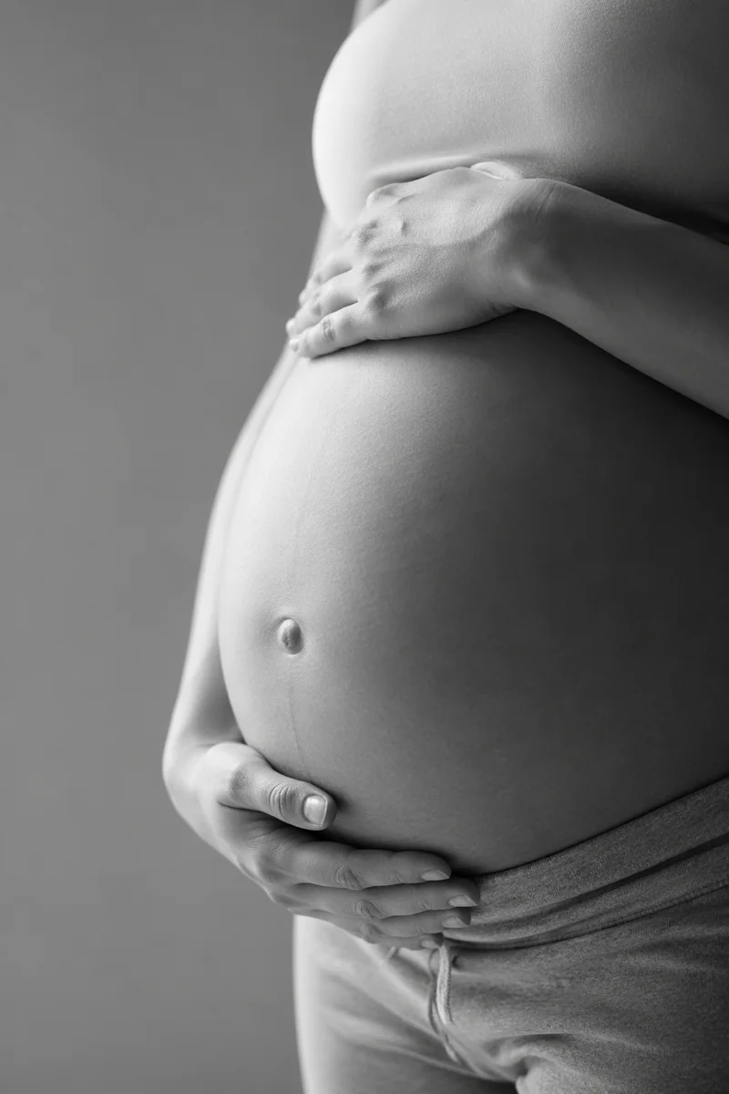 Monochrome Maternity Belly Portrait in Medical Setting