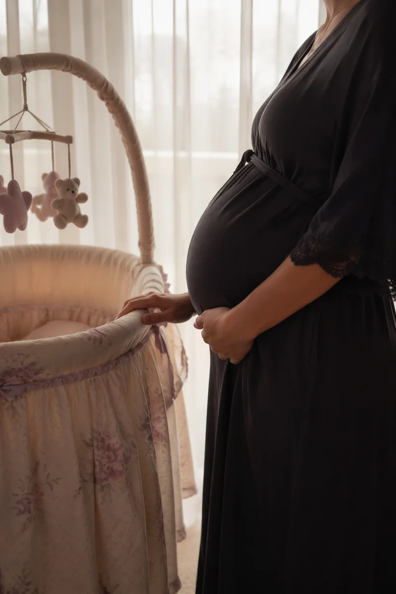 Expectant Mother Beside Nursery Bassinet