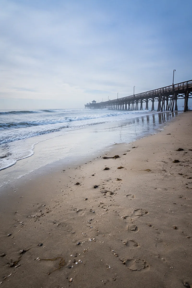 Quiet Summer Beach With Misty Wooden Pier