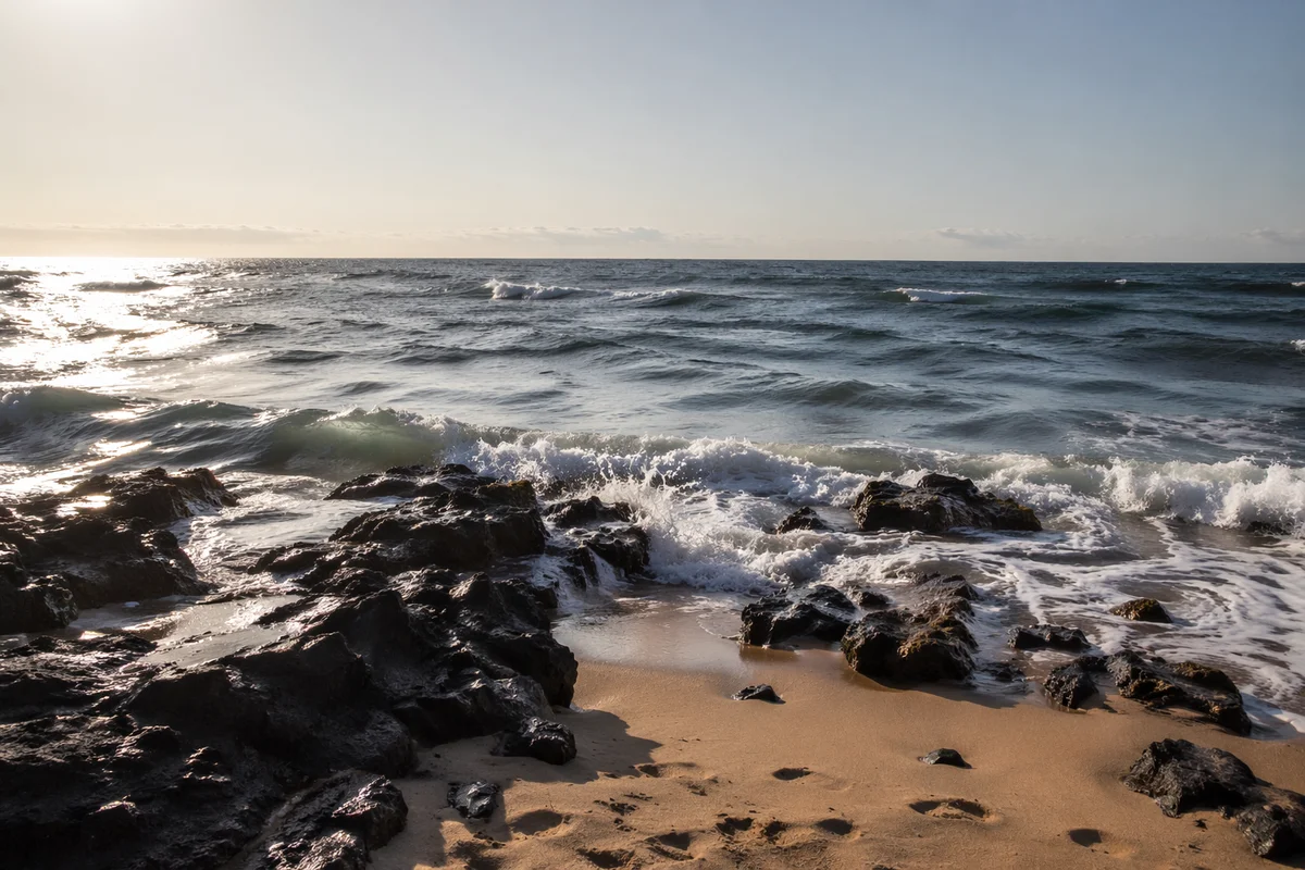 Summer Waves Over Volcanic Beach Rocks