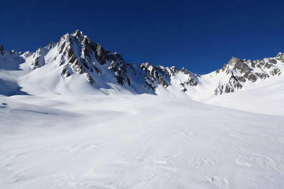 Silent Snowy Alpine Peaks Under Cobalt Sky