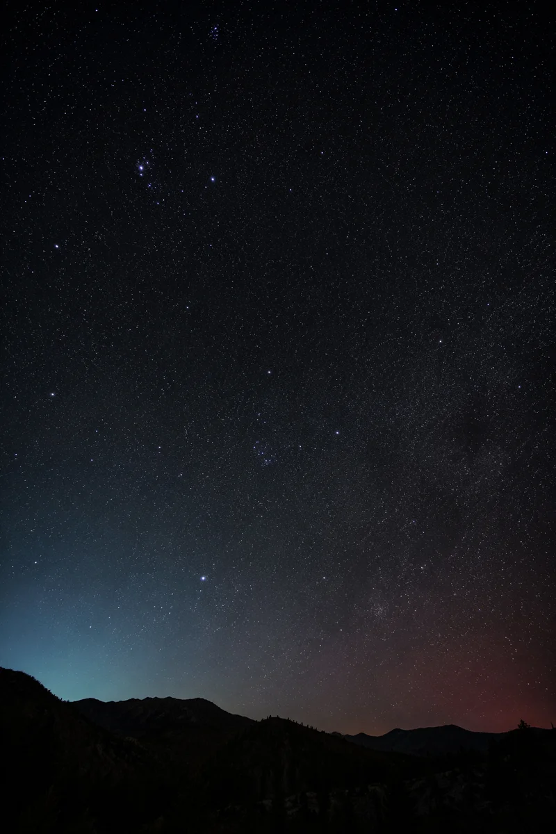 Serene Starry Night Over Mountain Silhouette