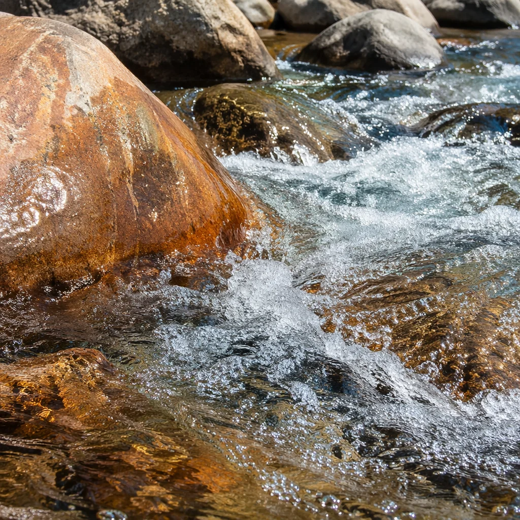 Clear Mountain Stream Over Weathered Boulders