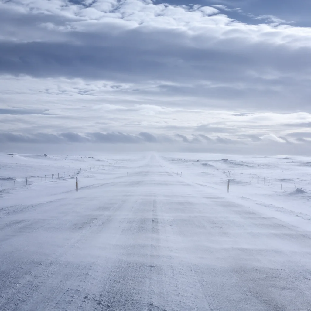Blizzard Sweeping Across Remote Winter Road