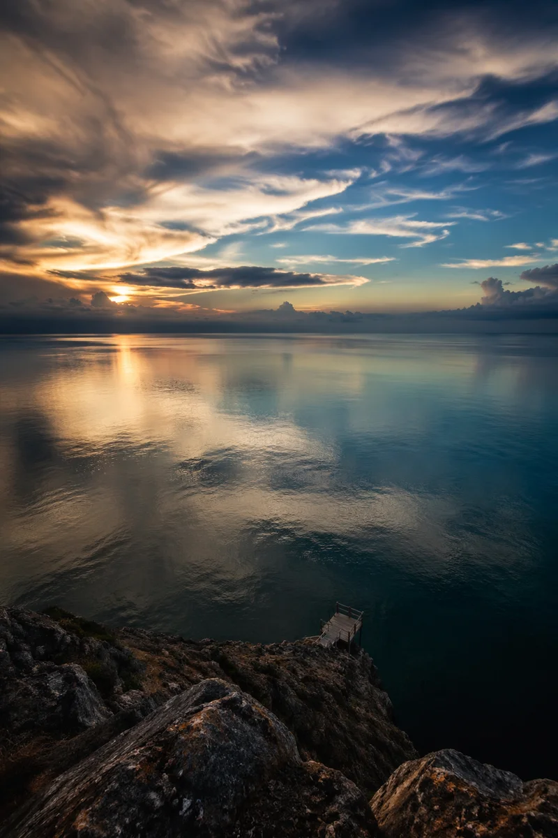 Cliff Edge Over Serene Blue Ocean Horizon