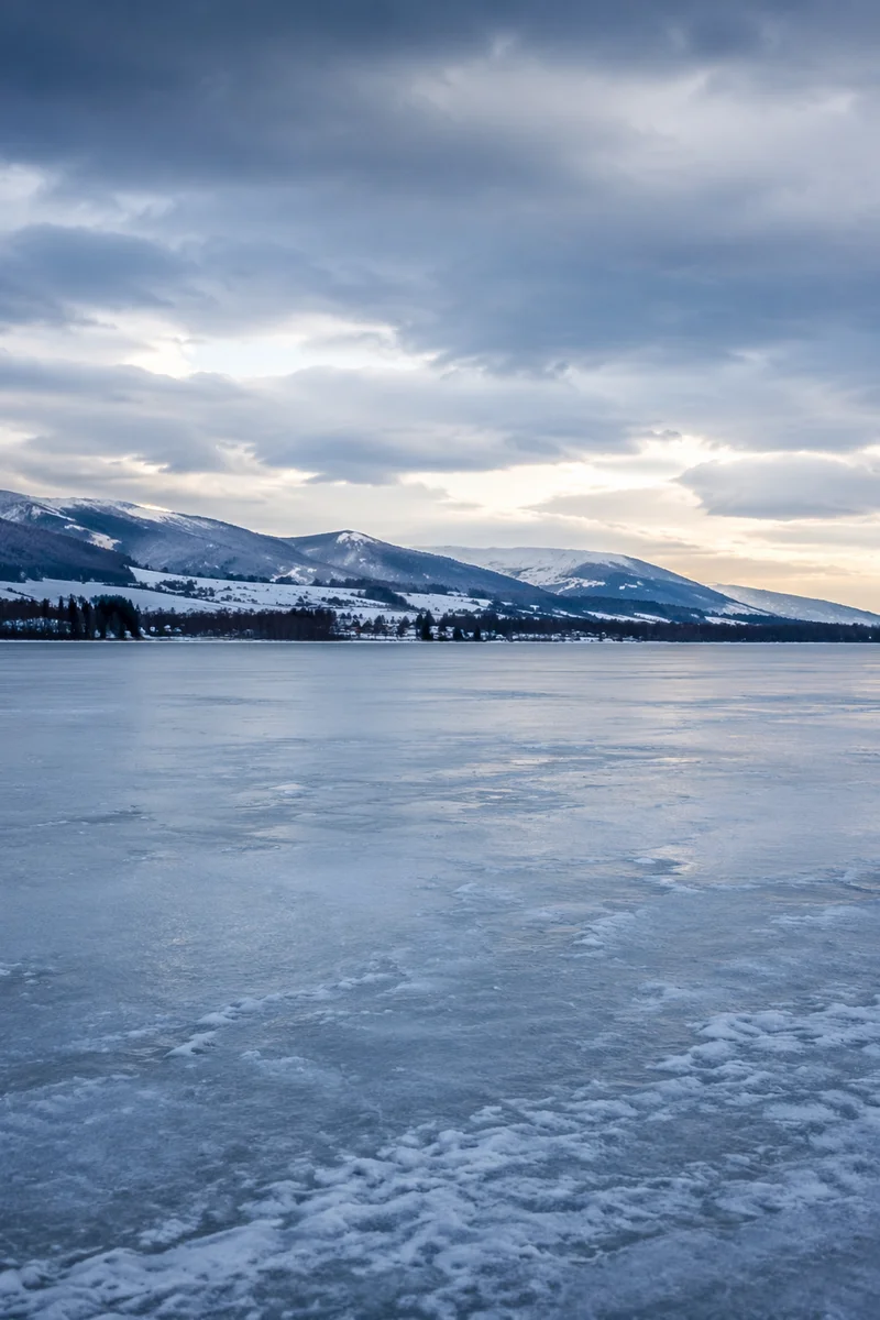 Frozen Lake and Snowy Mountain Reflections