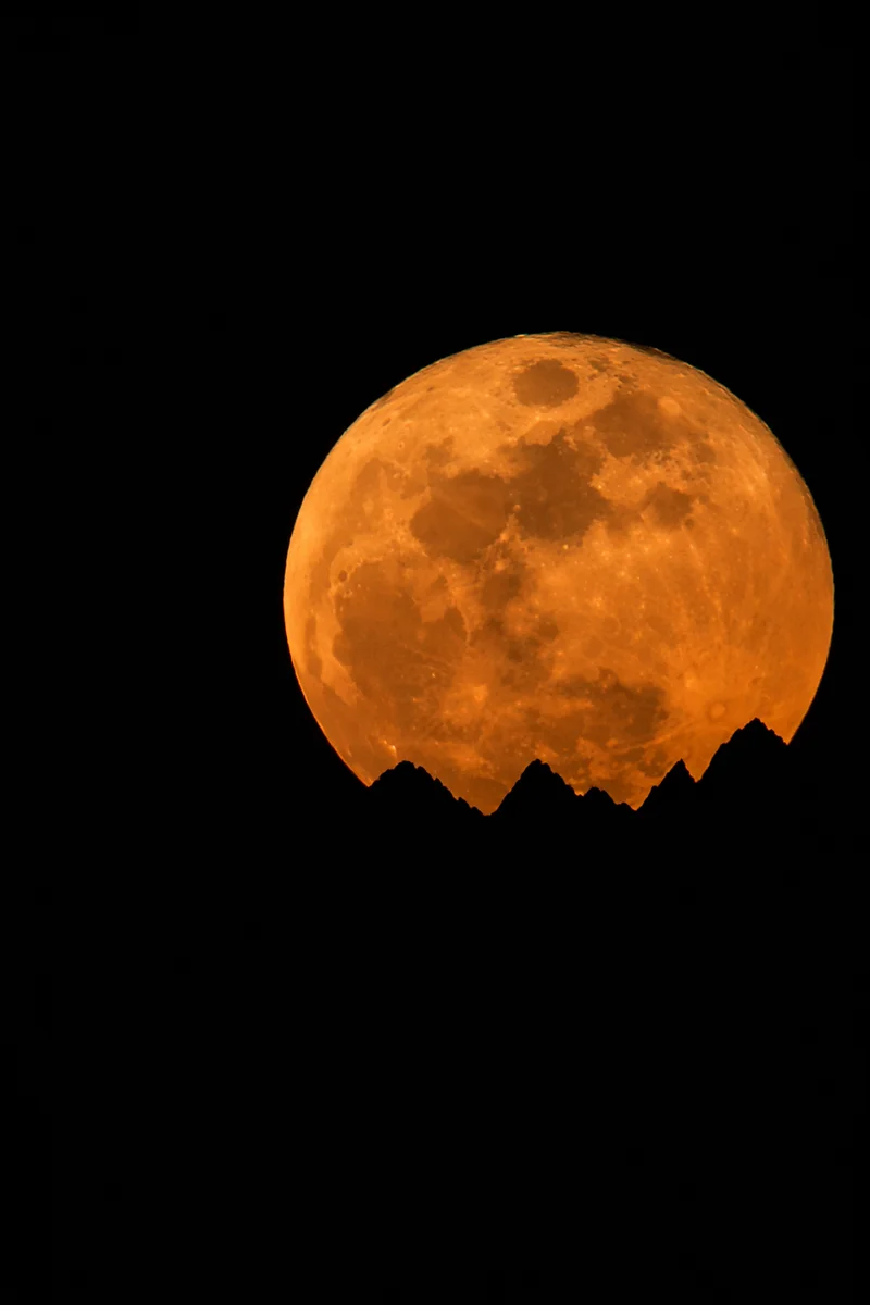 Amber Full Moon Over Mountain Silhouette