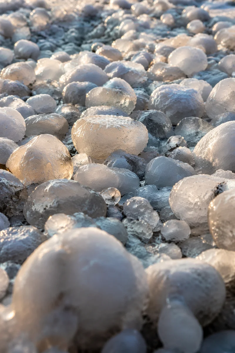 Macro Hailstones on Frozen Ground After Storm