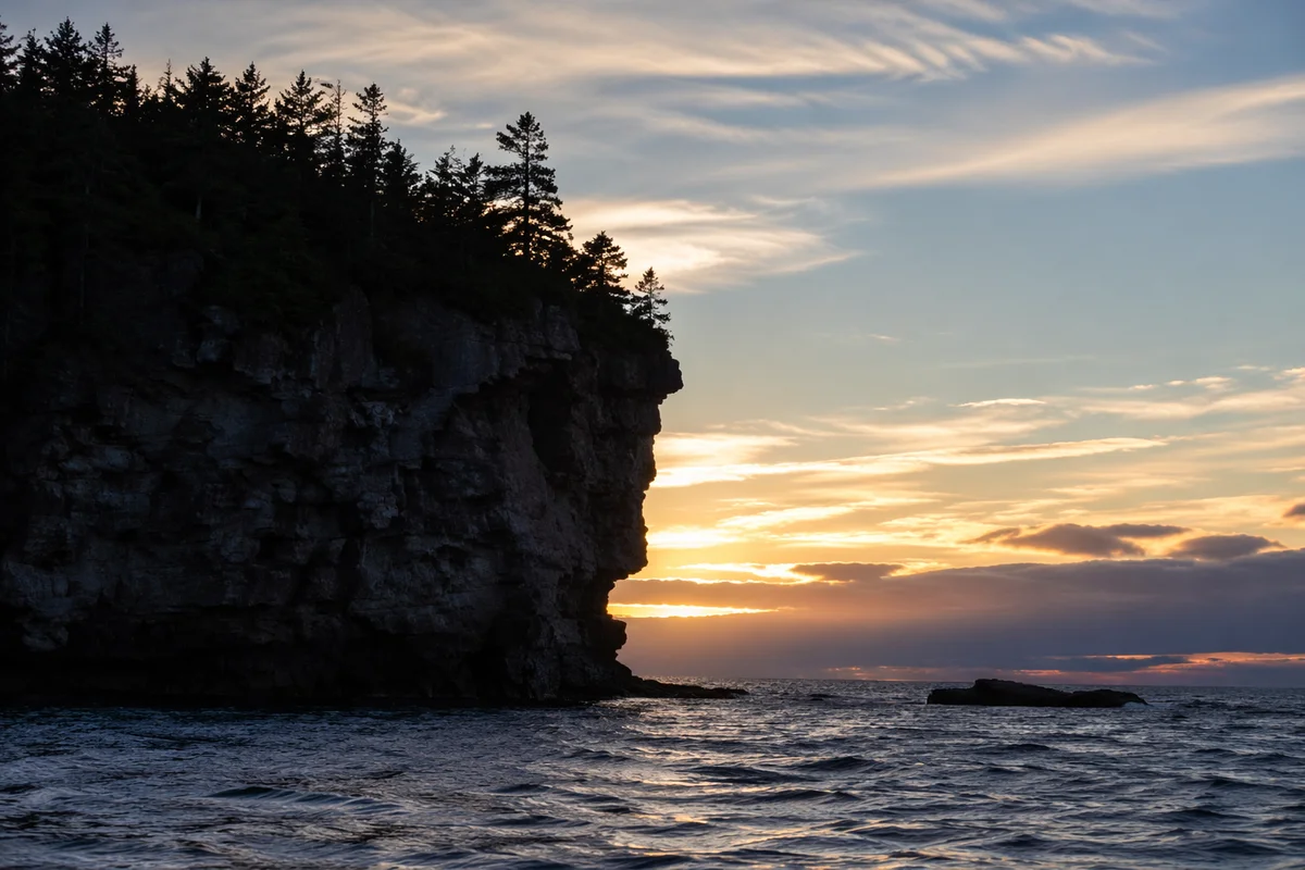 Ocean Sunset Silhouette with Rugged Limestone Cliffs