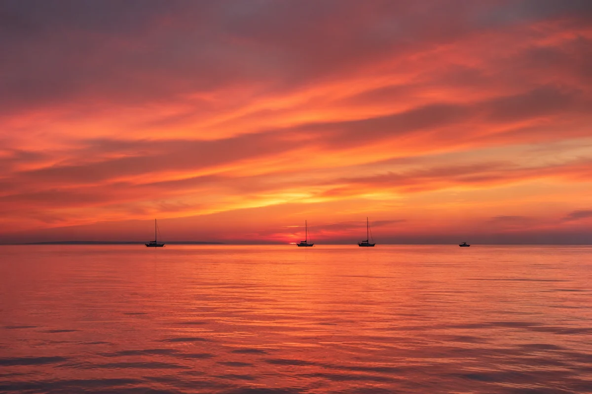 Peaceful Sailboats on Ocean Sunset Horizon