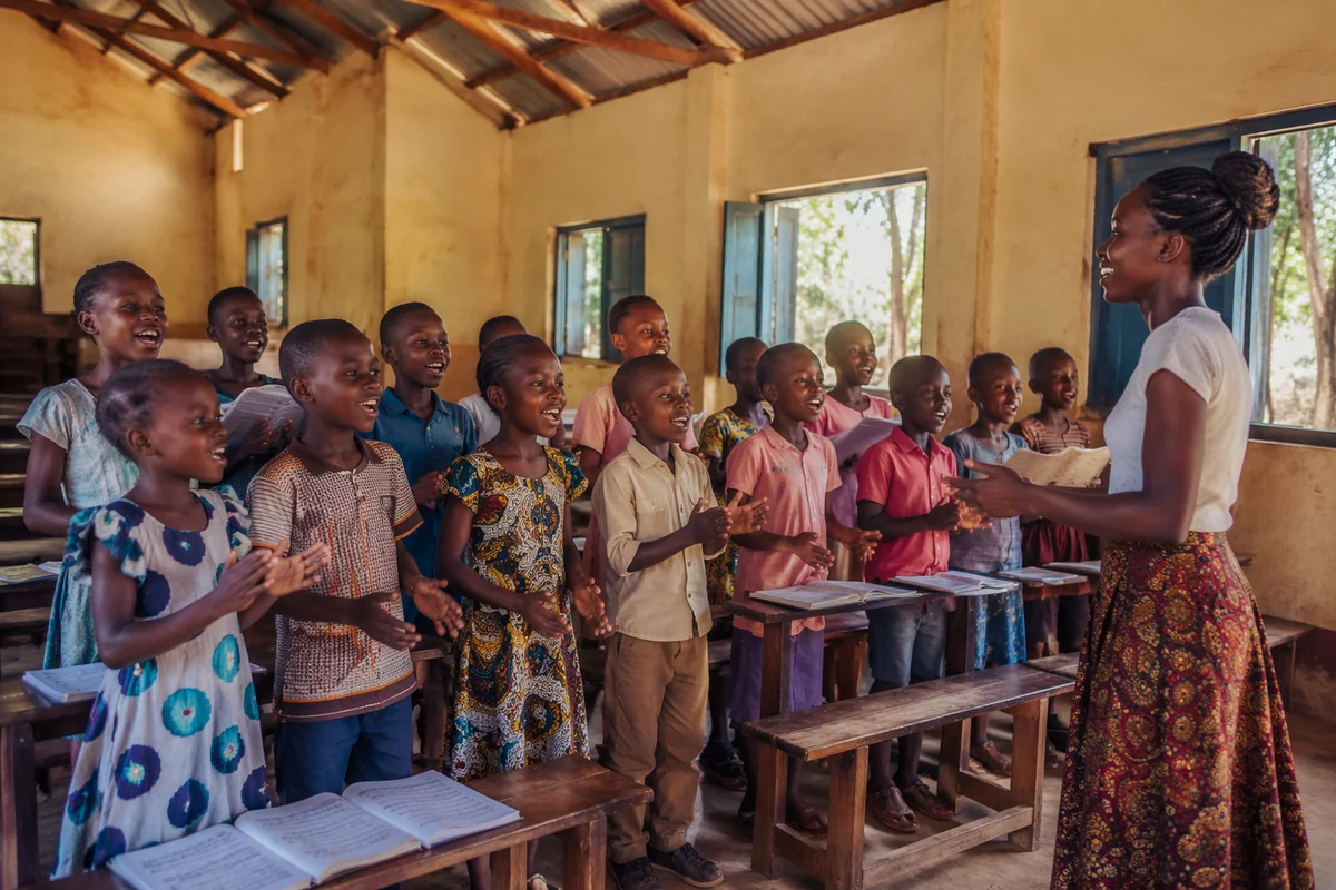African Children Singing in School Hall