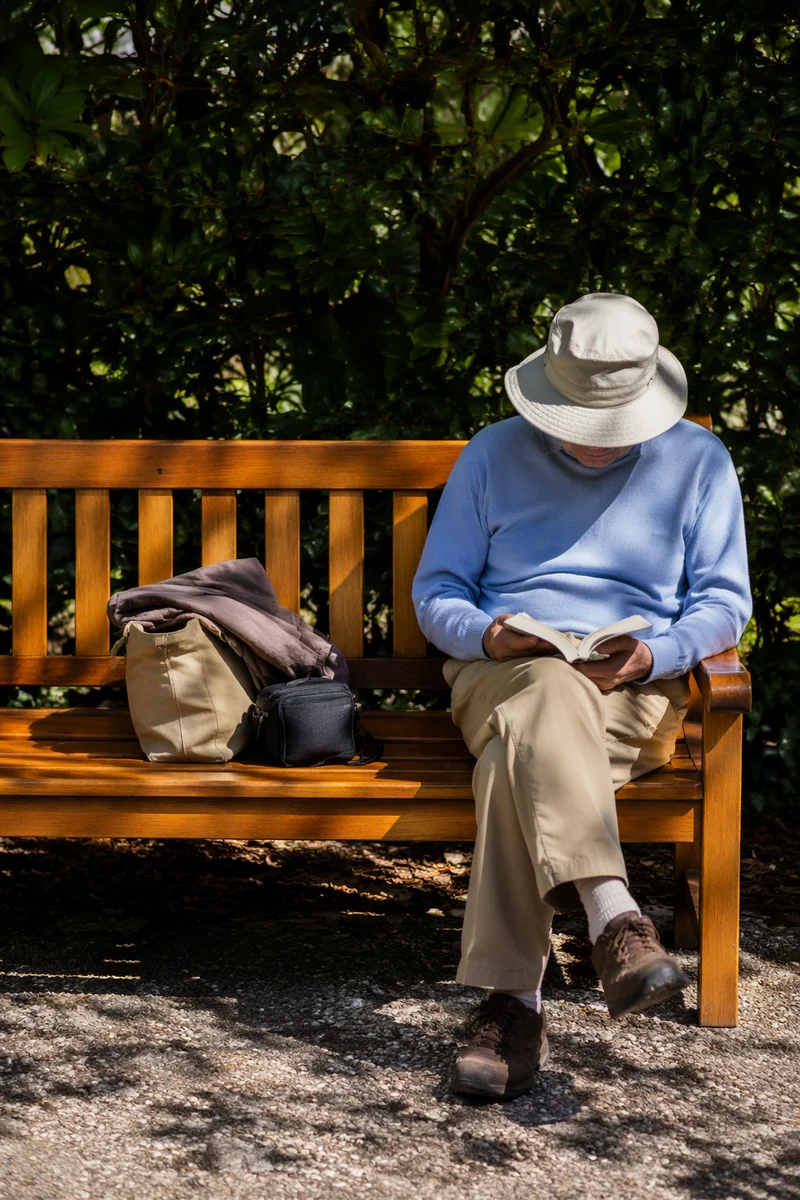Elderly Asian Man Reading Bible Outdoors
