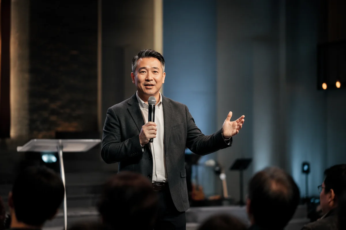 East Asian Pastor Preaching on Church Stage