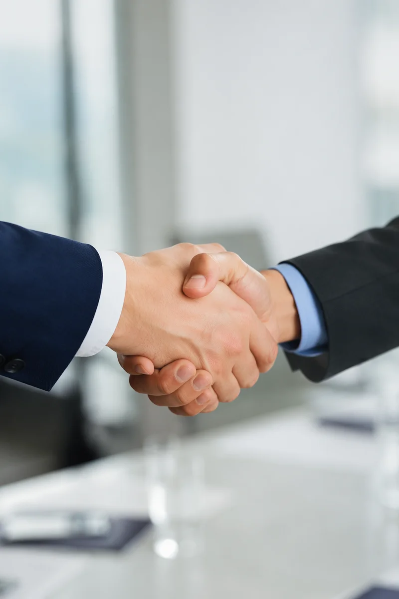 Professional Handshake in Modern Office Meeting