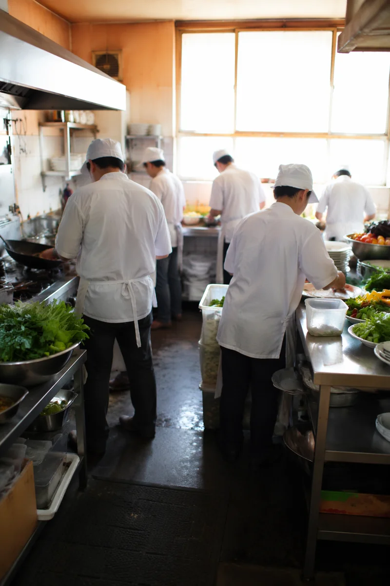 Busy Chefs Preparing Food in Kitchen