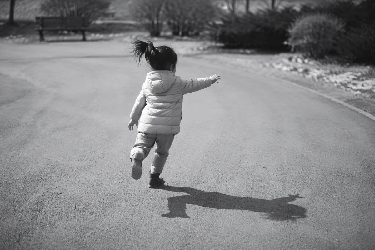 Joyful Child Running Through Quiet Park