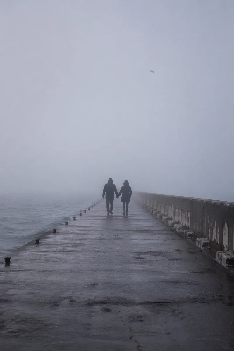 Romantic Couple Walking Through Seaside Fog