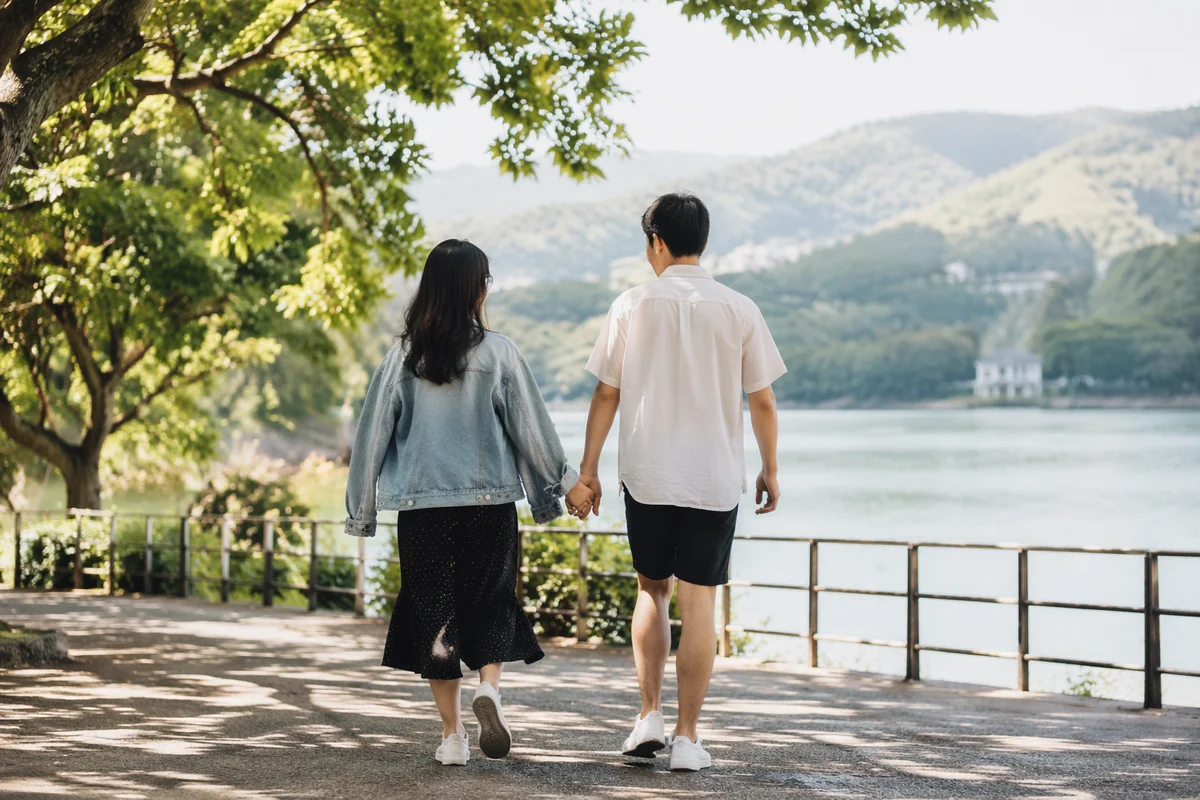 Romantic Couple Walking by Sunlit Lake