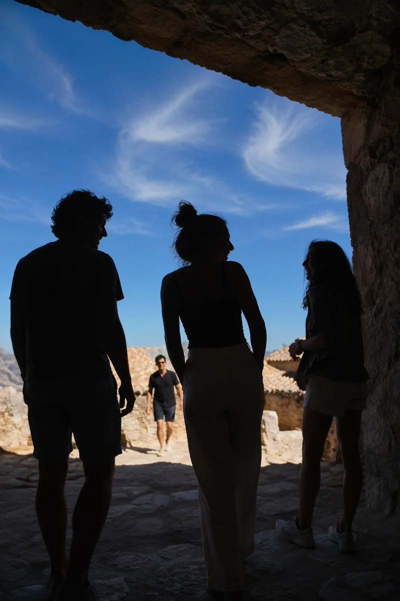 Laughing Friends Under Sunlit Stone Arch