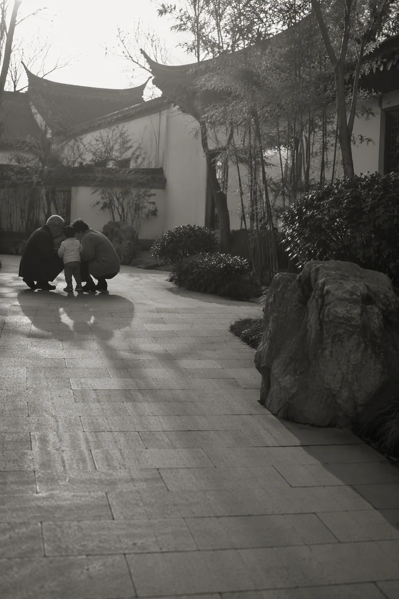 Grandparents and Grandchild in Quiet Courtyard