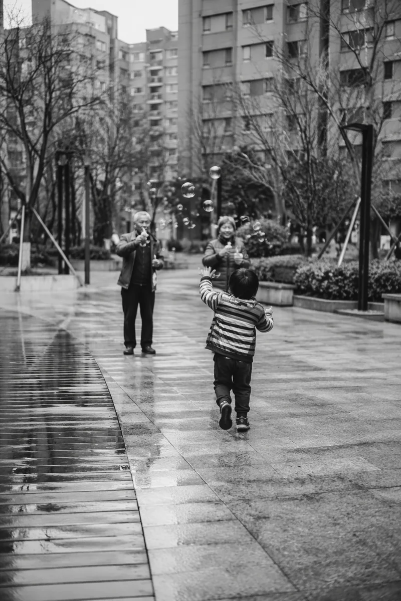 Grandparents and Grandchild Playing After Rain