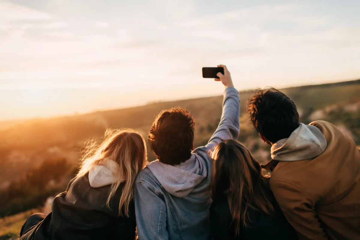 Joyful Friends Selfie on Golden Hillside